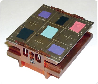 K-Alpha sample stage loaded with several sections of laboratory gloves mounted on double-sided tape