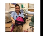 Healthcare support worker explains benefits of scalp cooling for cancer patients