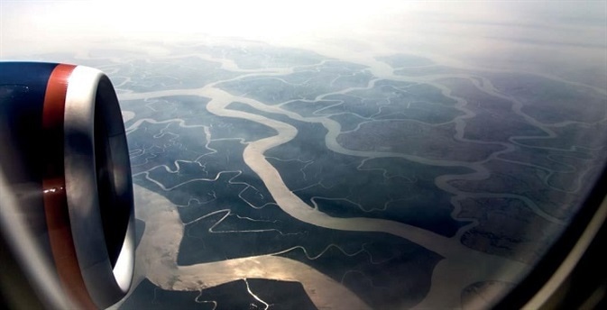 The Ganges Delta, as seen from an airplane. With a surface area of around 140 km2, it is the largest river delta in the world. The arsenic-rich sediments of the Ganges Delta are the source of the high arsenic concentrations in Bangladesh