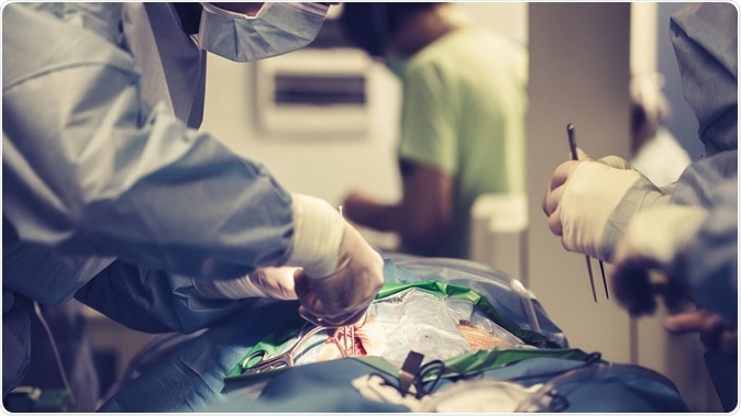Team of surgeons make a dissection for aortic valve repair in cardiovascular minimally invasive surgery hospital center. Image Credit: MAD.vertise / Shutterstock