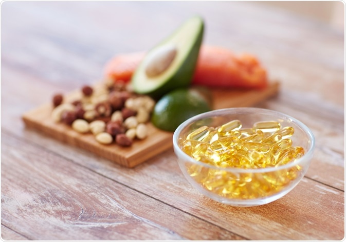 Photo of omega-3 supplements next to foods containing omega-3 - By Syda Productions