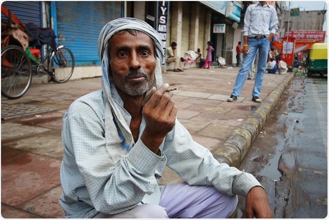 DELHI, INDIA - An unidentified man smokes a traditional