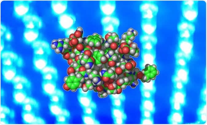 Researchers induced engineered pancreatic beta cells to secrete insulin when exposed to blue light. Insulin is shown here as a space filling atomic model. Image Credit: Tufts University