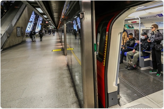 People wearing face masks taking Jubilee Line underground train. Image Credit: Vudi Xhymshiti / Shutterstock