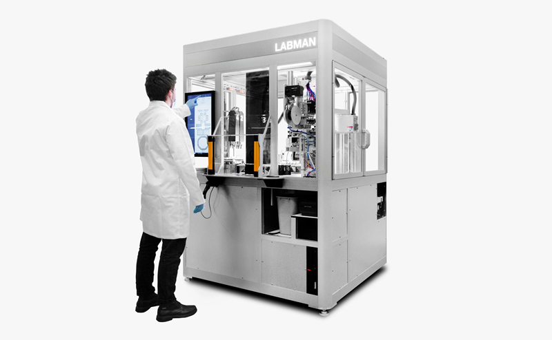 Male scientist interacting with the user interface of a large piece of Labman technology.