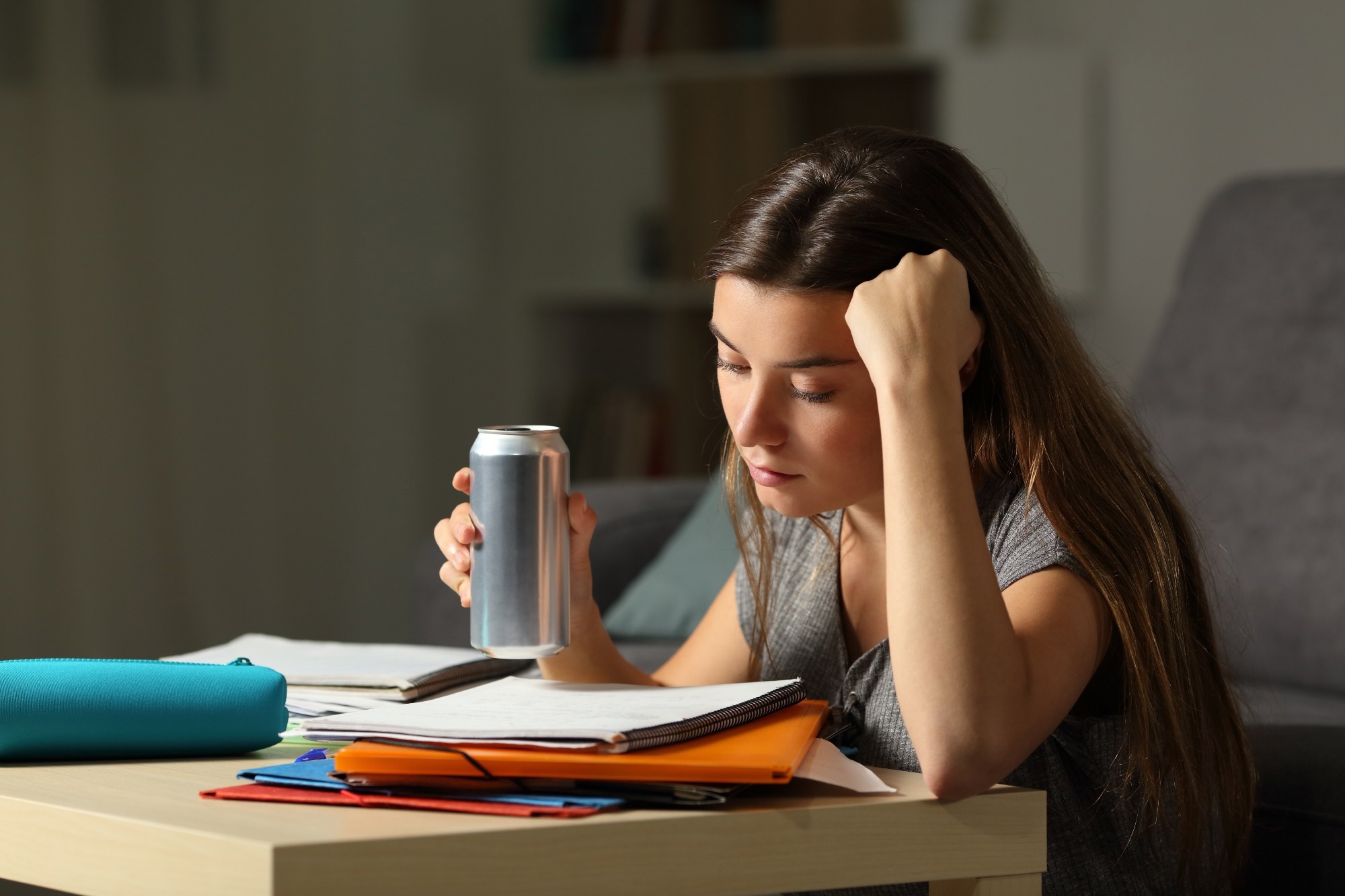 Student studying and drinking an energy drink