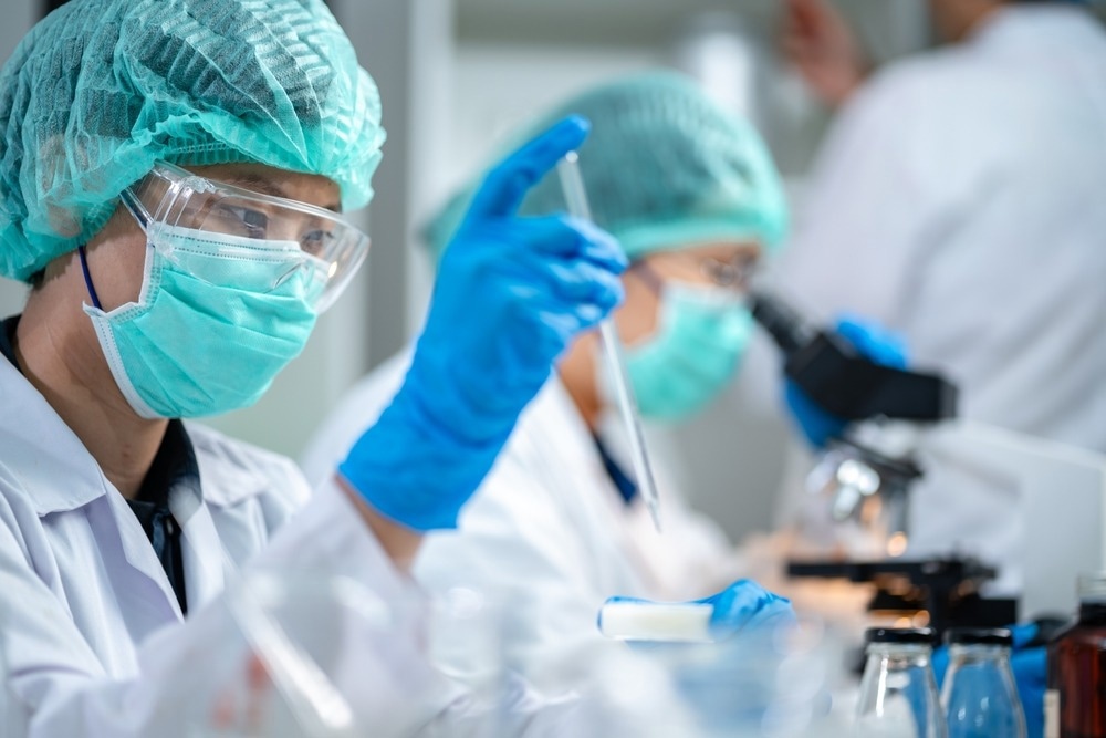 Scientists are working on a sample of milk in a biotechnology laboratory