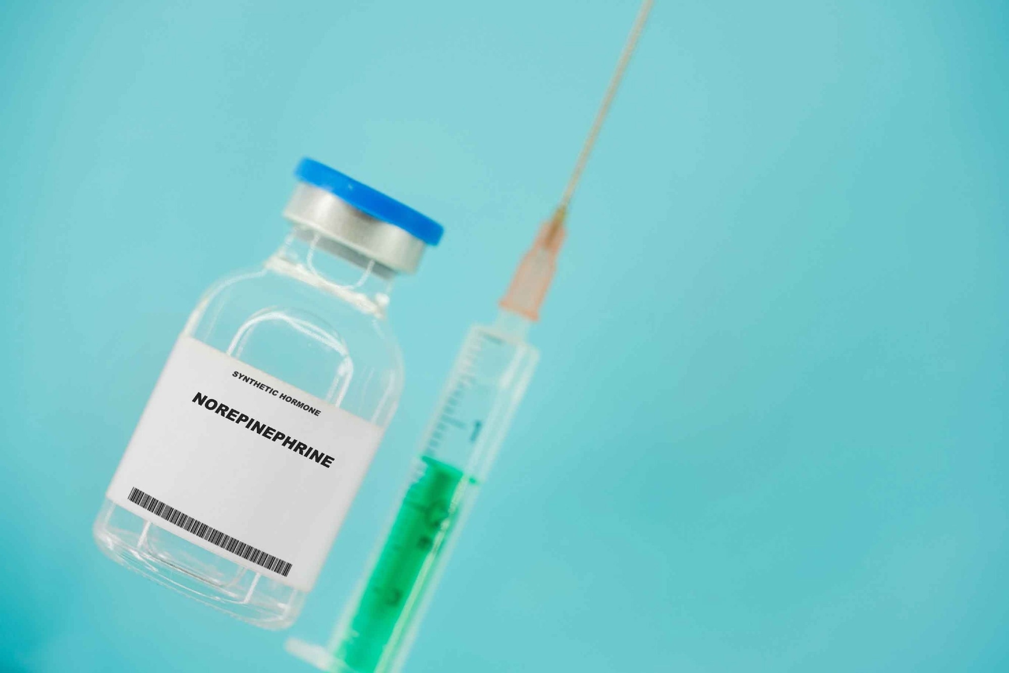 a bottle of norepinephrine with a syringe