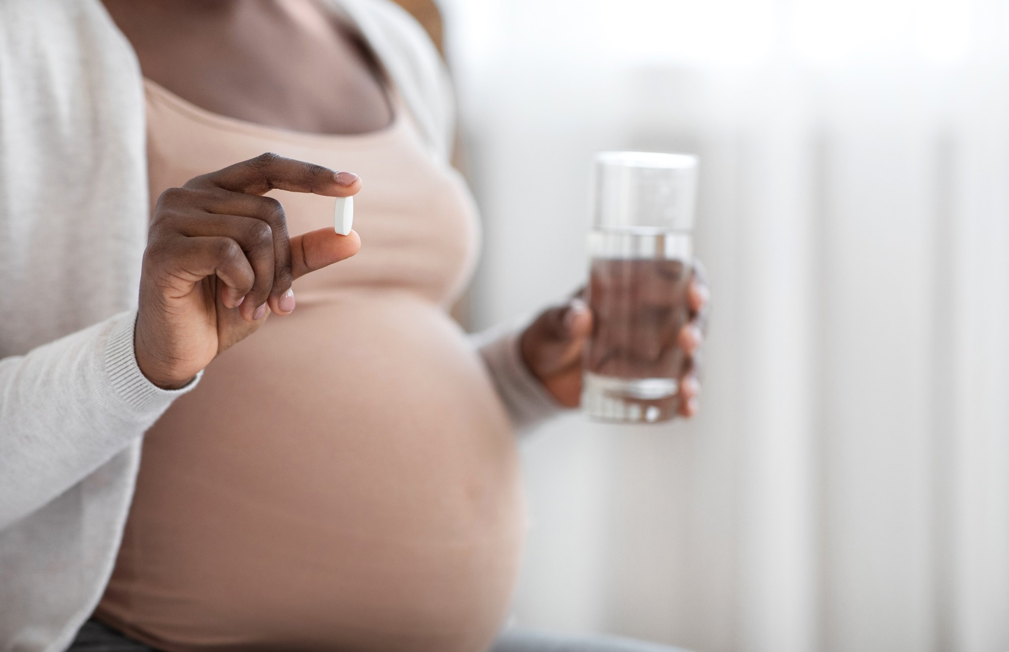 Lady Holding Pill In Hand And Glass Of Water,