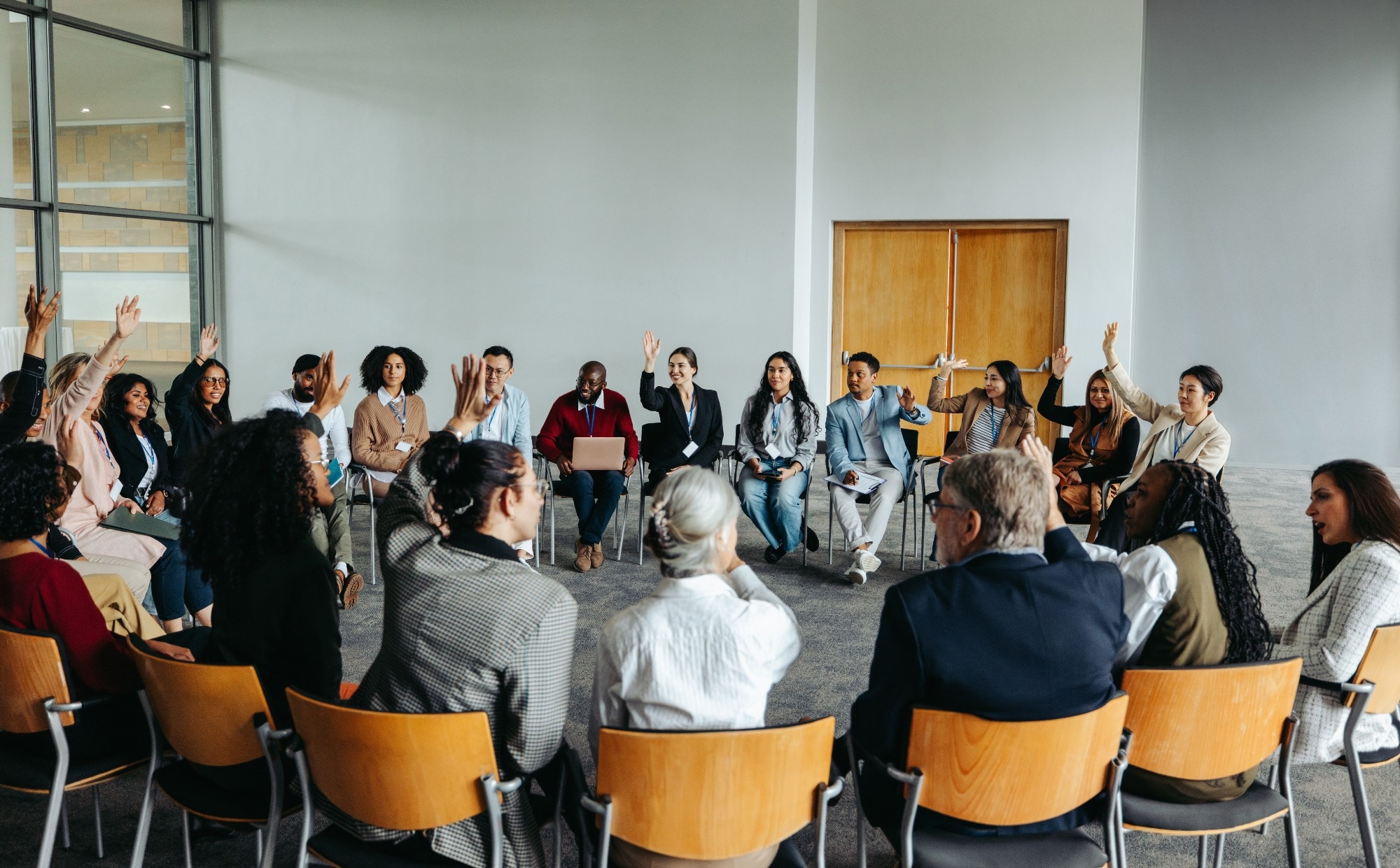 Group of diverse people participating in a support group meeting.