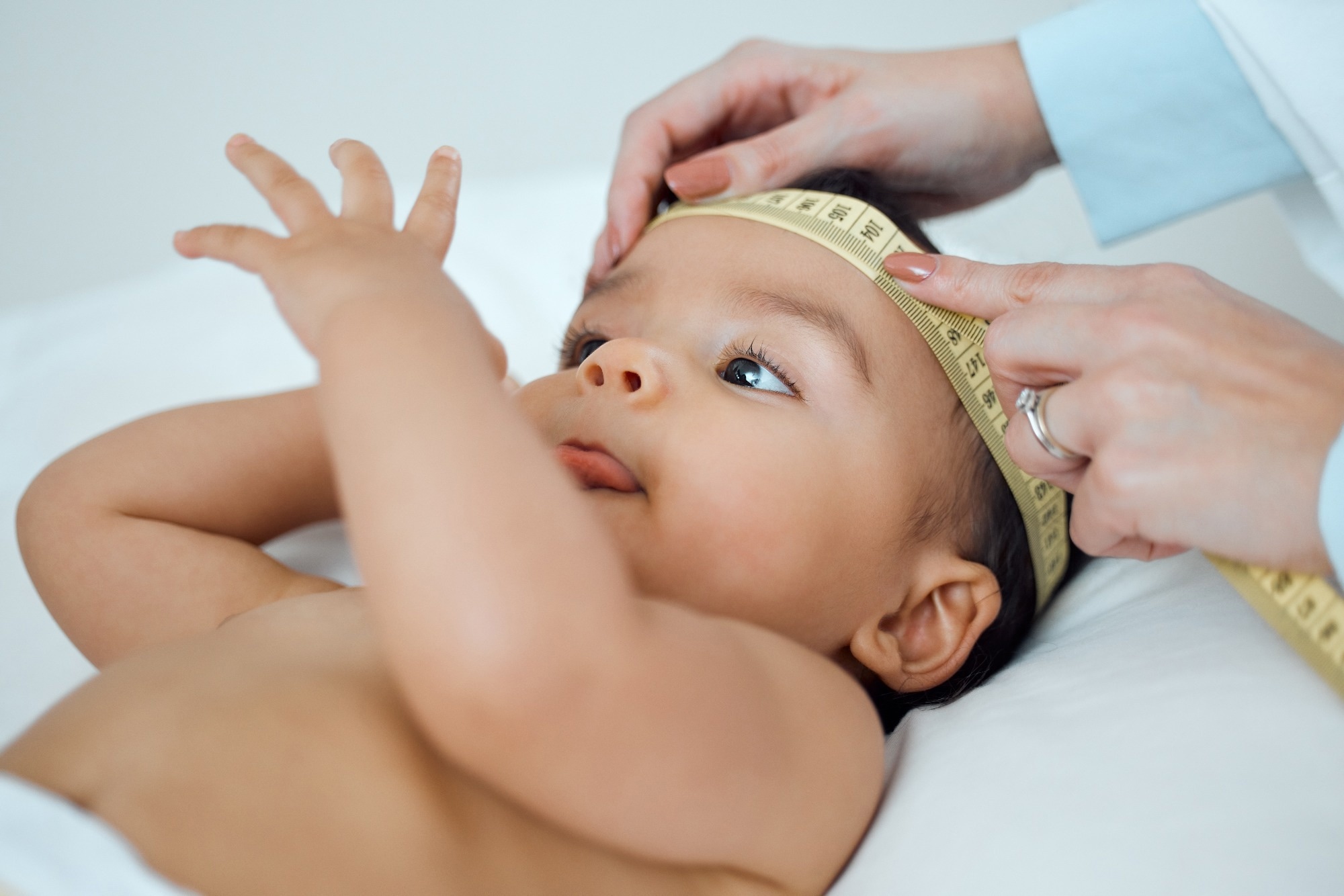 Baby head being measured with a tape measure