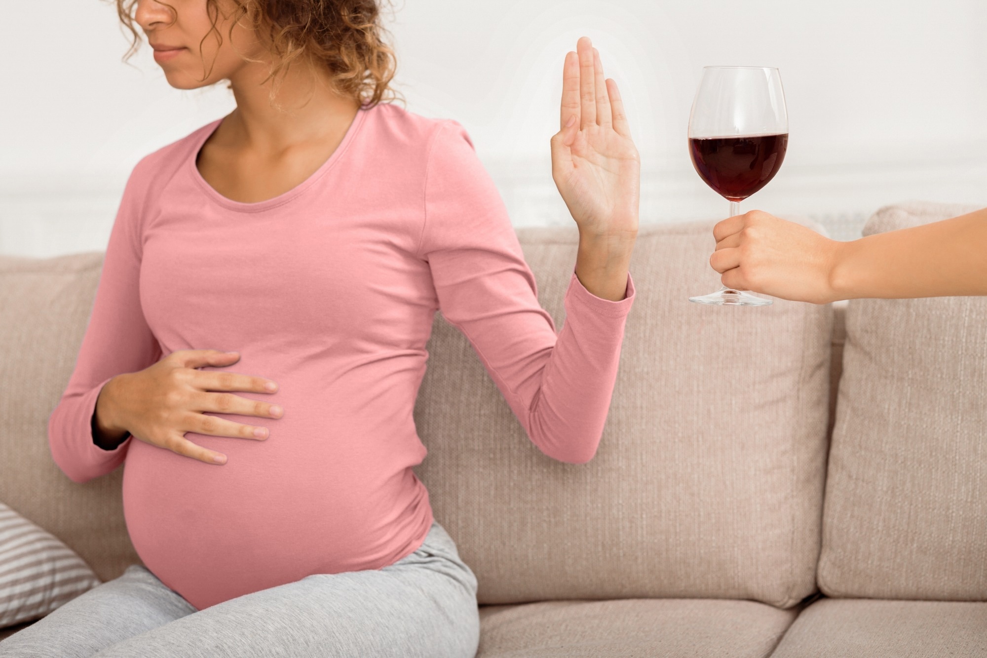 Pregnant woman refusing glass of wine